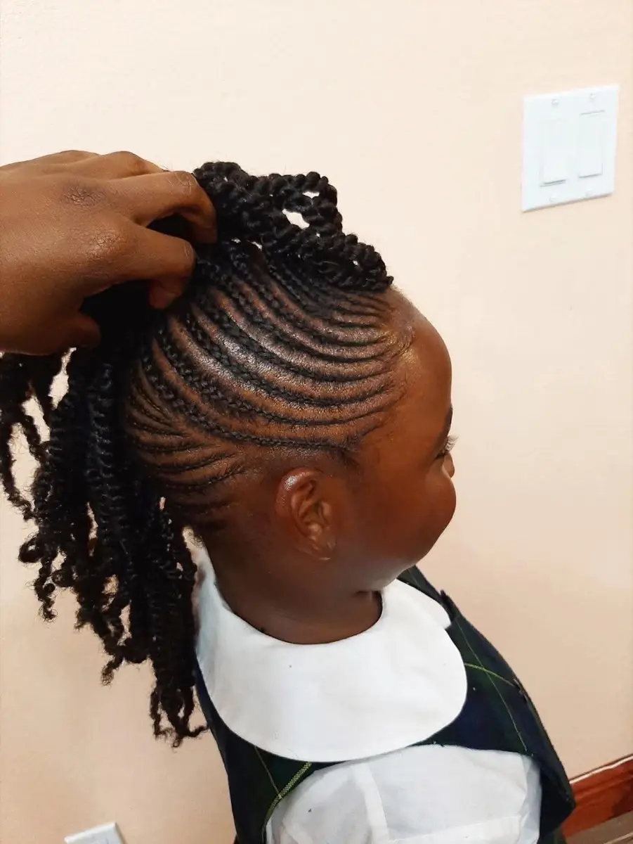 Child's braided ponytail with curved cornrow parting