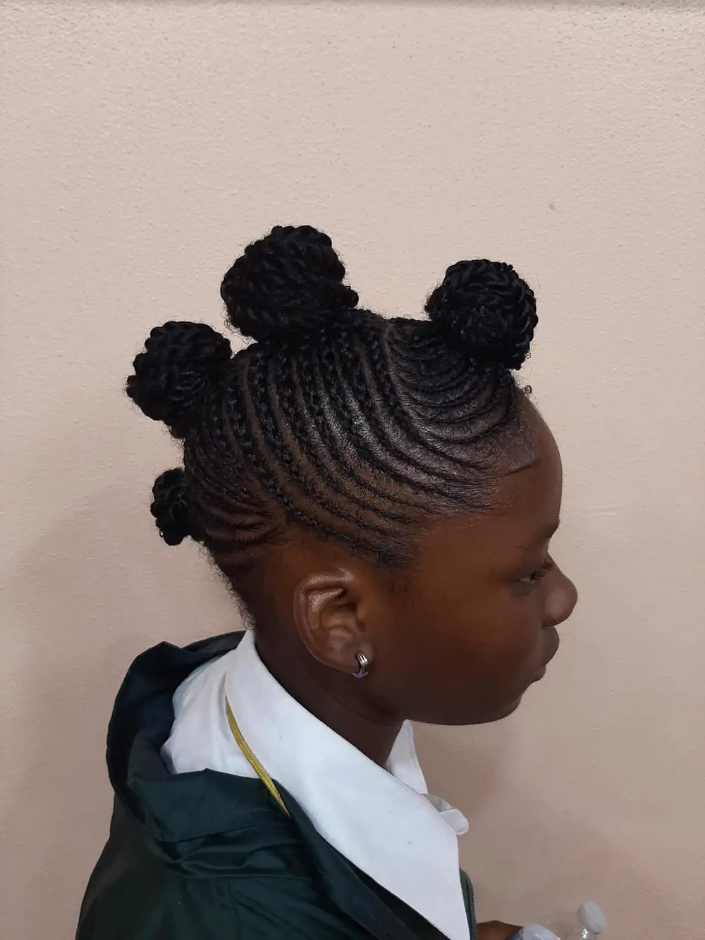 Cornrow style finished into two rounded buns
